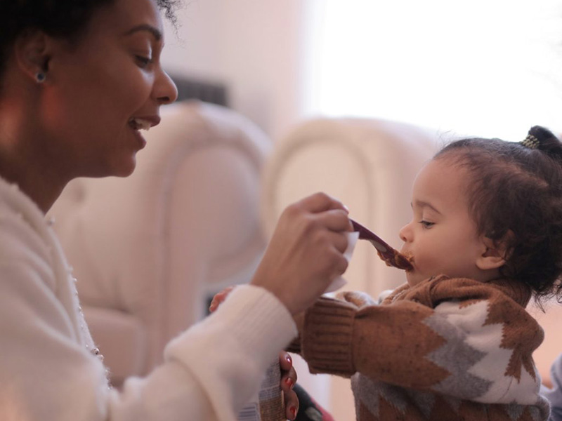 Mother feeding child.