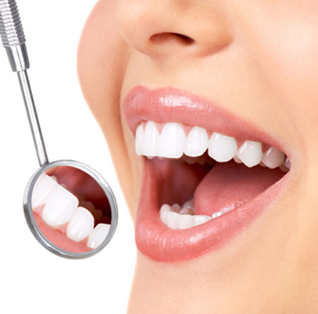 A woman inspects her teeth with a magnifying glass