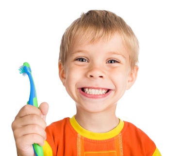 small boy holding toothbrush