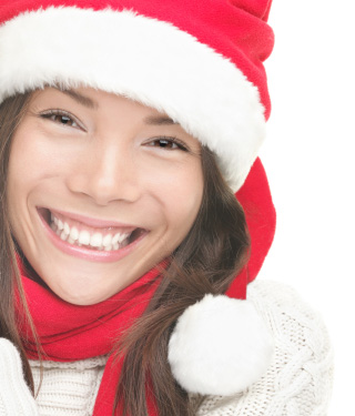 A girl smiling wearing Christmas cap