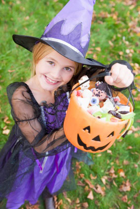 Girls holding bucket full of candies