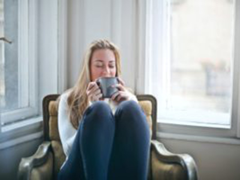 Woman sipping her coffee. Dentists agree it's best to brush teeth before you eat breakfast.