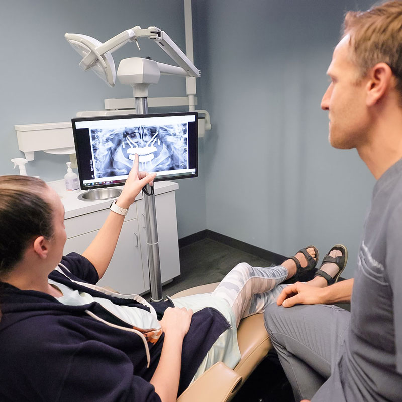 dentist showing patient digital xrays