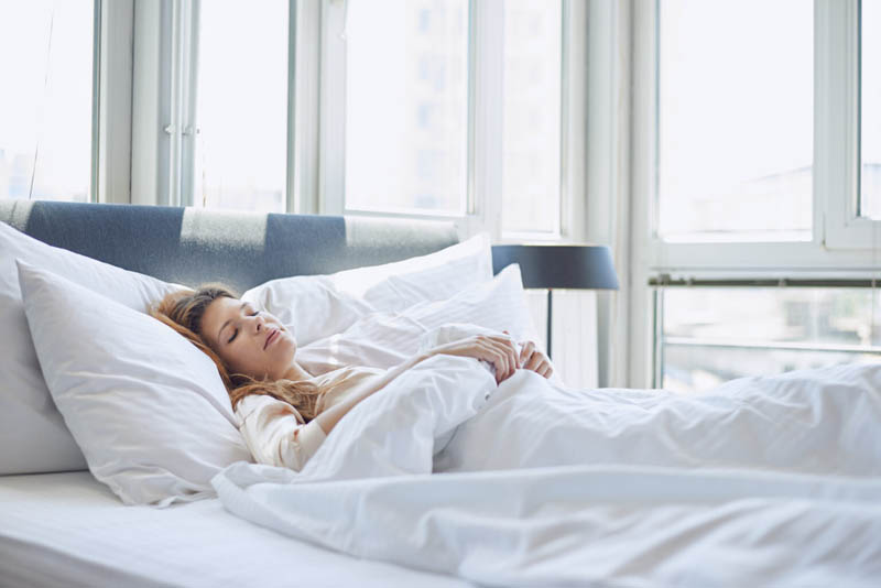 Young woman sleeping in bed