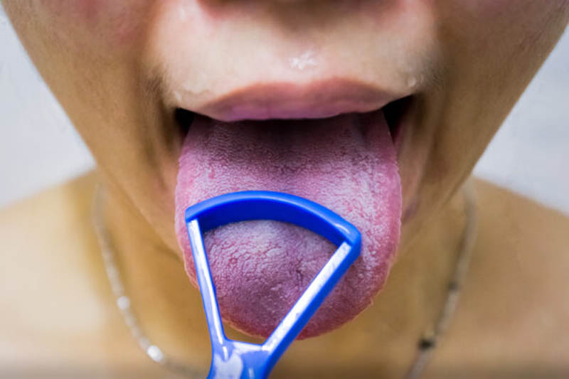 Tongue Scraper on a Tongue in the Shower