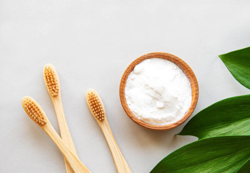Wooden bamboo eco friendly toothbrushes, baking soda on white b