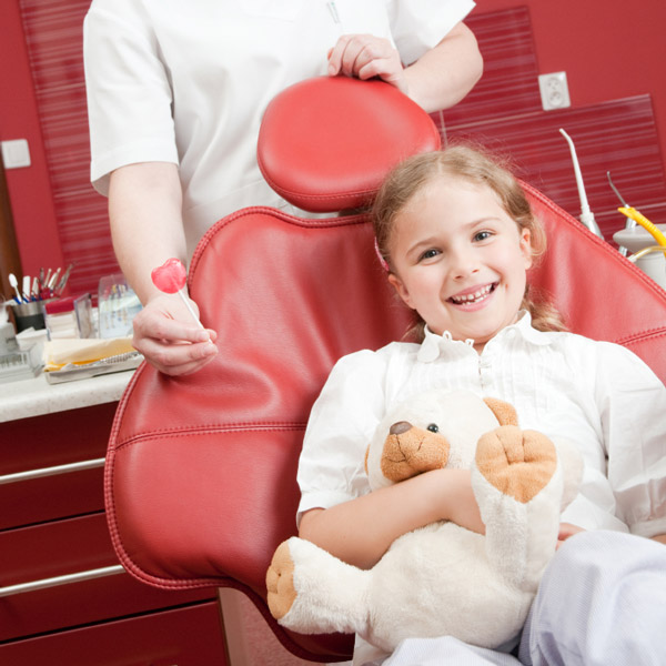 A young girl sitting in a dentist chair