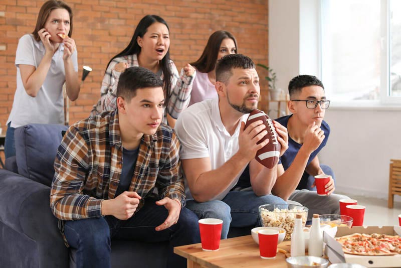 Friends watching rugby match