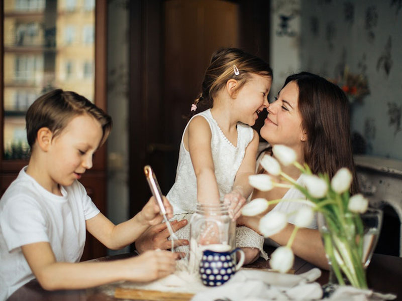 Mother laughing with her son and daughter.