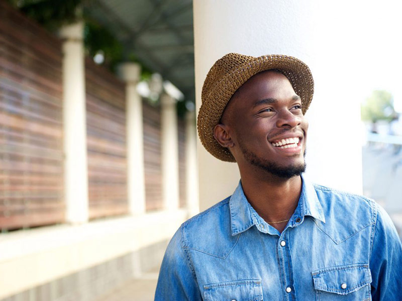 A man looking at right and smiling