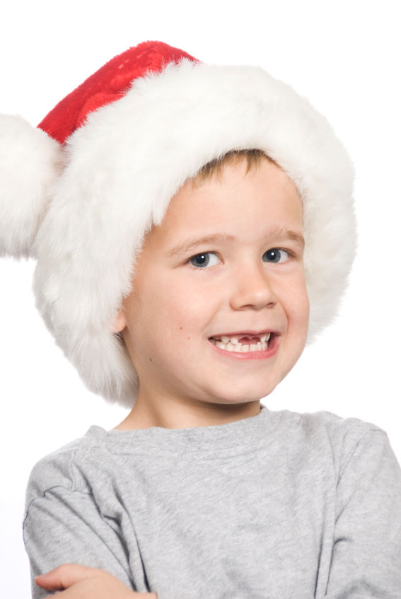 A young boy joyfully wearing a festive Santa hat
