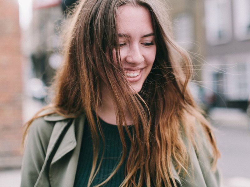 Young woman laughing and looking down