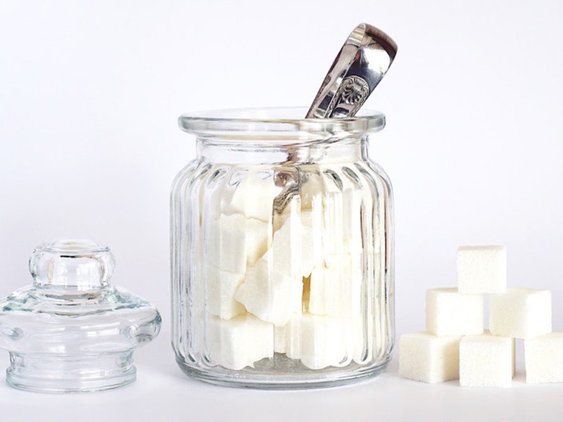 Glass jar containing cubes of Xylitol