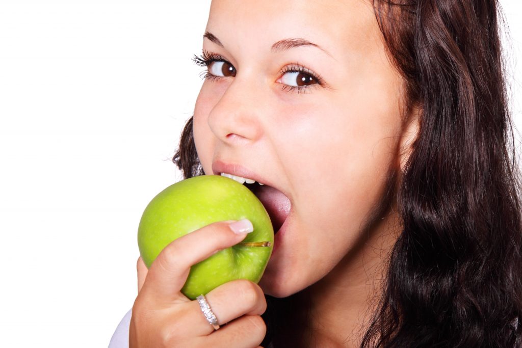 Woman eating an apple