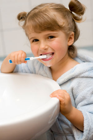 A young girl brushing her teeth