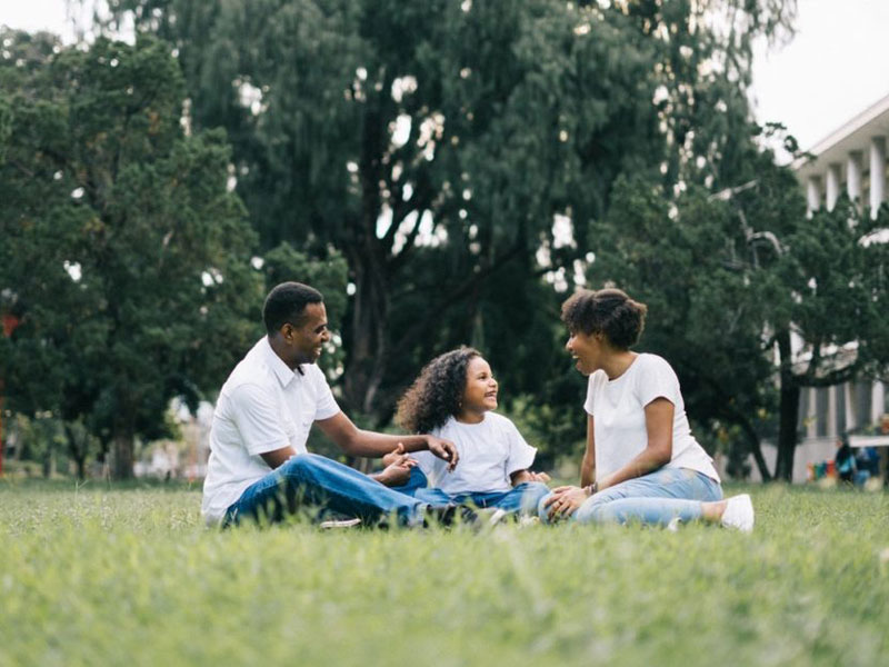 family sitting in park