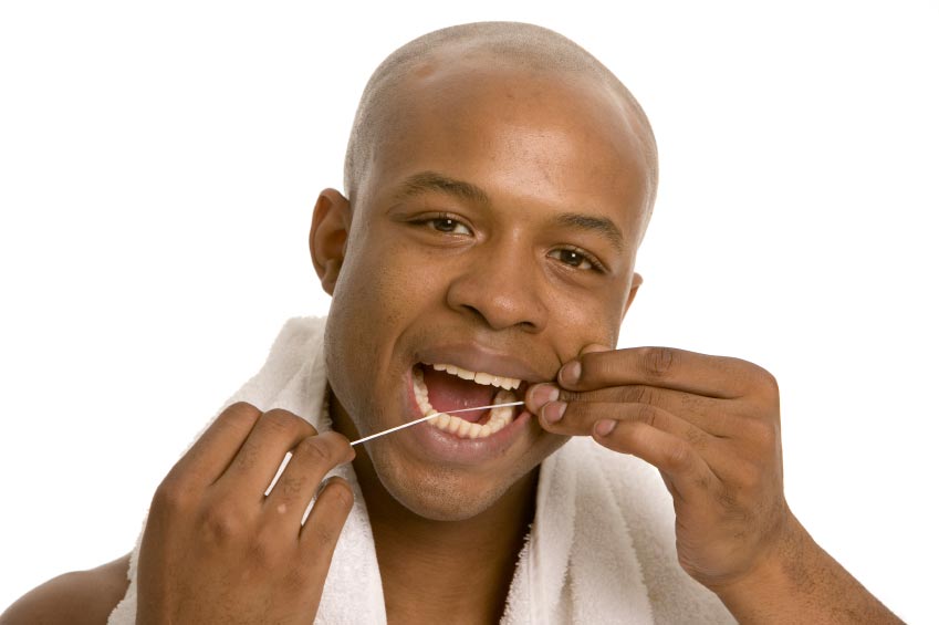 man flossing his teeth