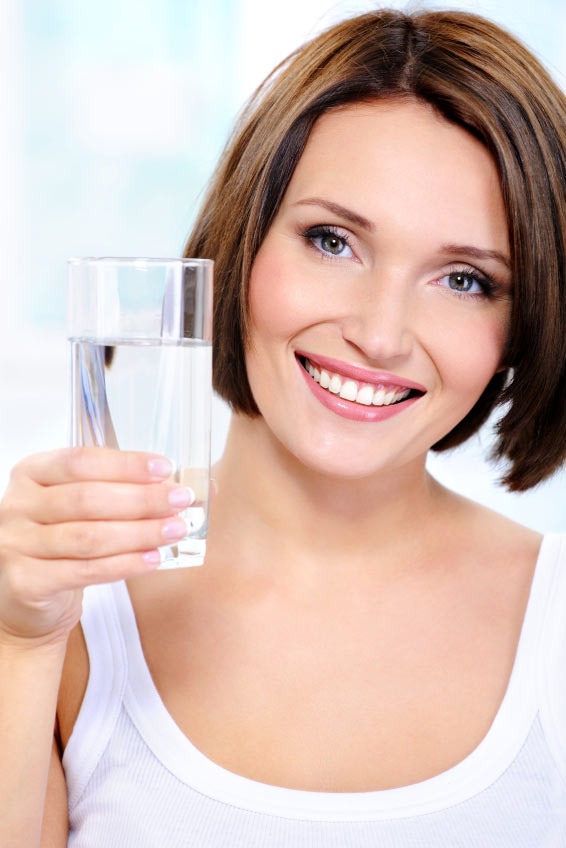 woman holding a glass of water