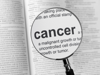 A newspaper highlighting the word cancer