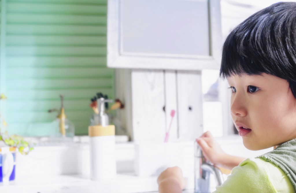 small girl brushing teeth