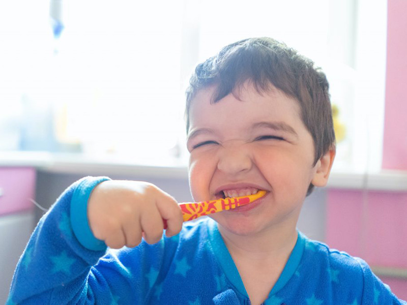 Little boy brushing his teeth.