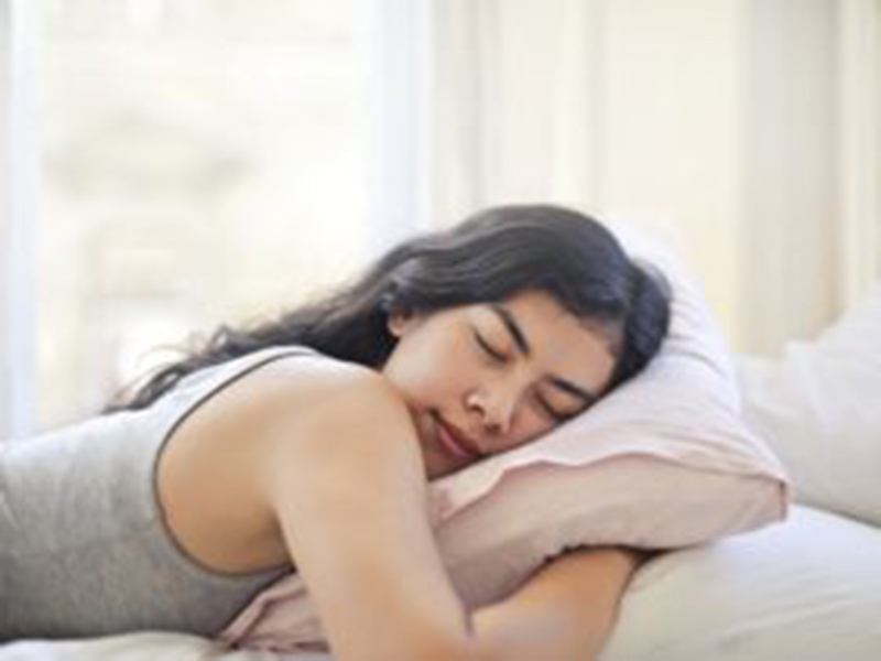 Woman sleeping with pillow. Learn how mouth breathing affects your health.