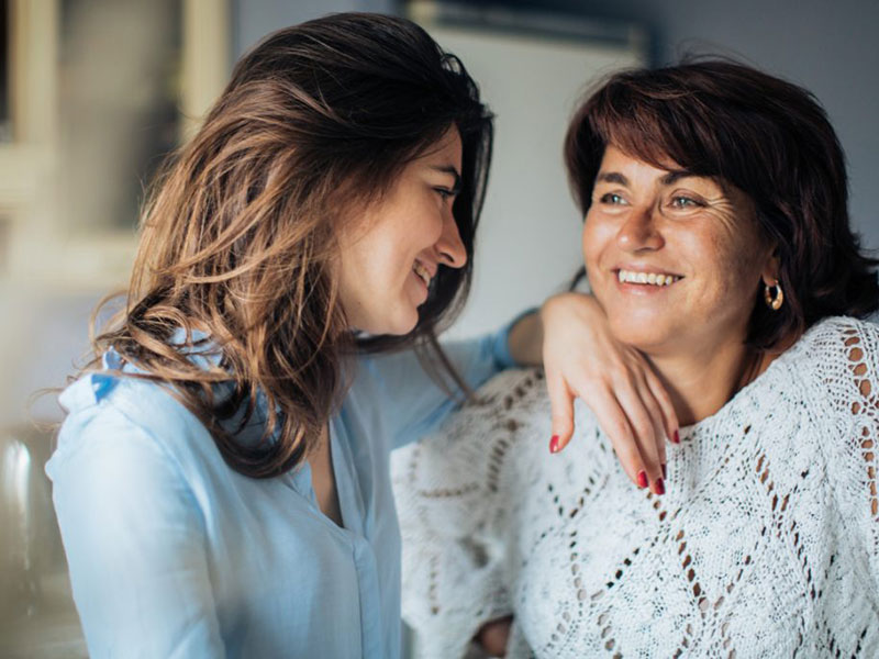 Mother daughter smiling.