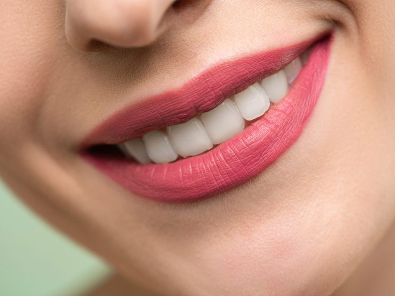 Smile with straight white teeth. Straightening your teeth with Invisalign can bring quite a few benefits.