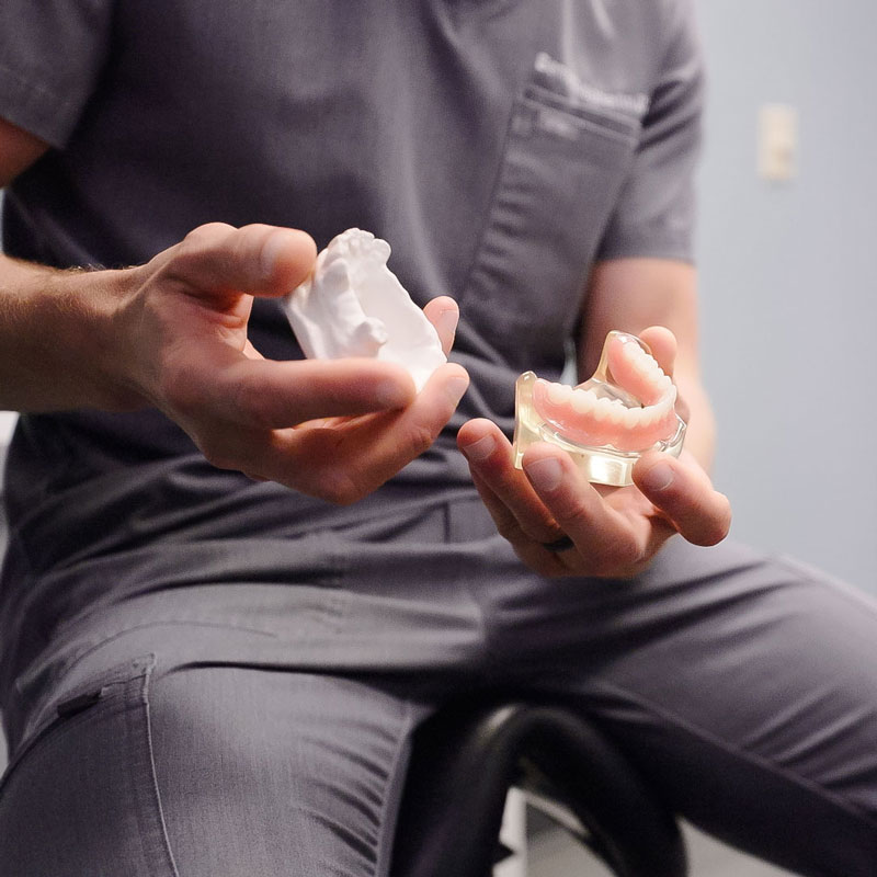 dentist holding dentures
