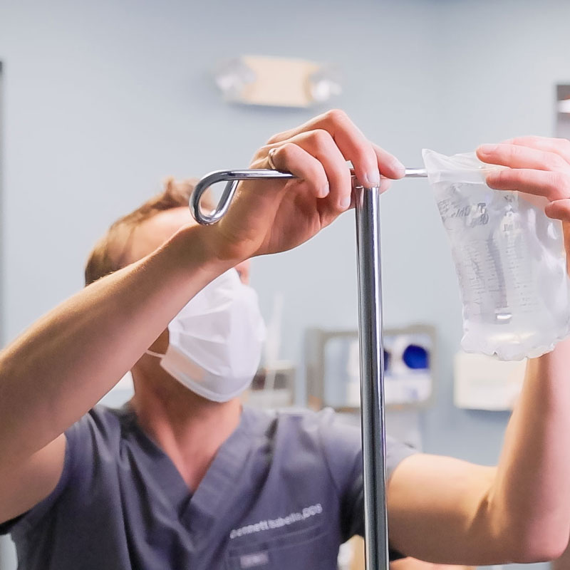 dentist hanging an IV bag