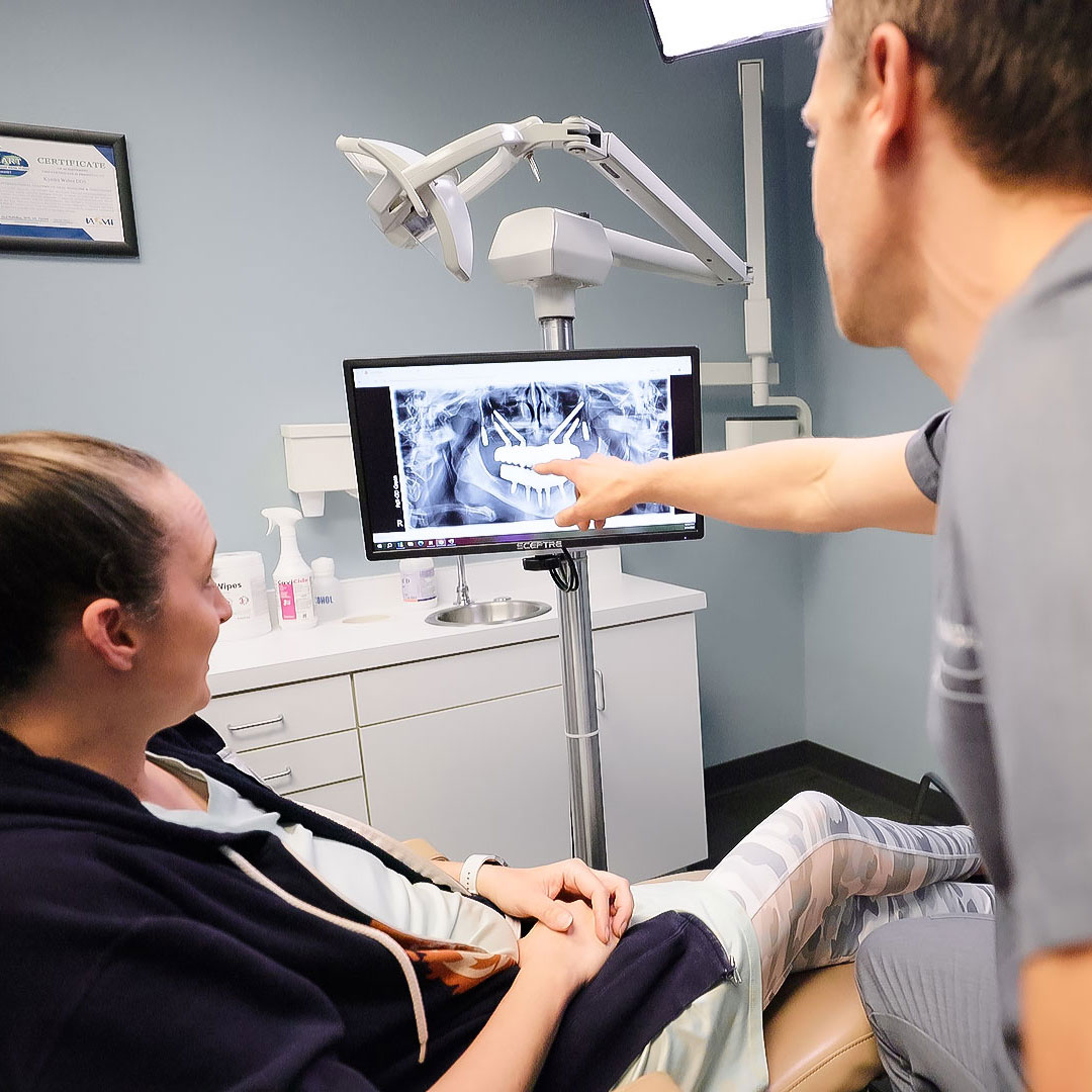 dentist showing patient digital xrays