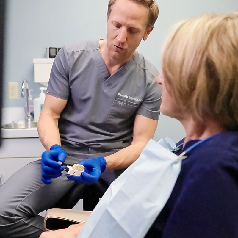 dentist showing patient teeth